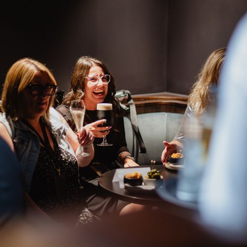 Guests socialising over drinks in a hospitality lounge